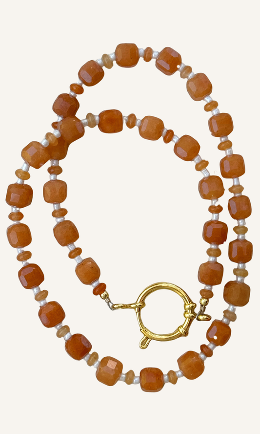 Orange Aventurine gemstones in various sizes with white spacer beads, gold filled findings, and a sailor clasp