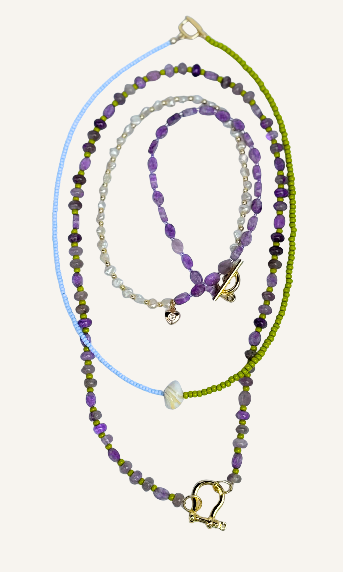 Purple Amethyst and Lepidolite necklace with green spacer beads gold filled findings and a horsebit carabiner tiny freshwater pearl with heart charm seed bead and mother of pearl with toggle