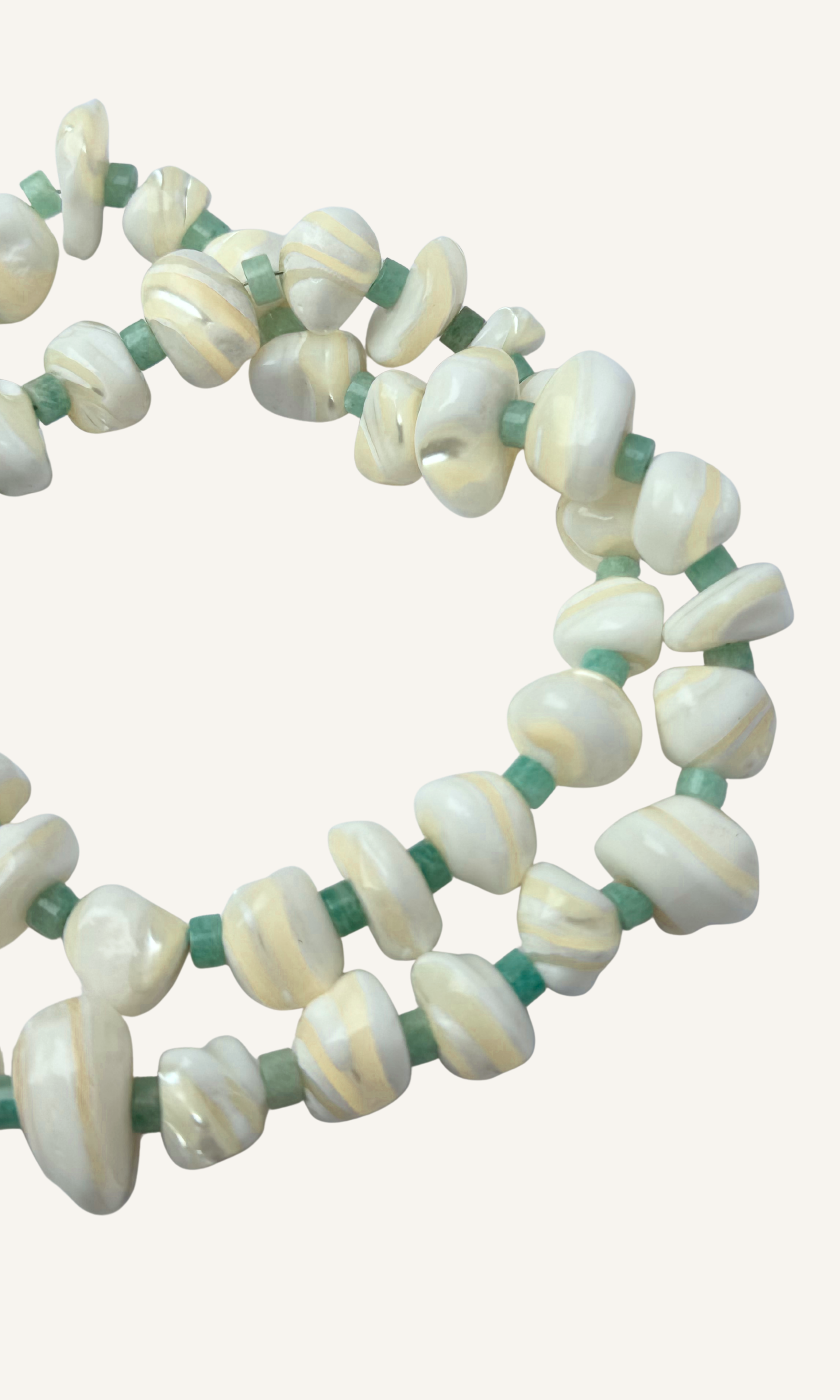 Mother of Pearl and Amazonite necklace with hammered hollow heart charm, gold filled findings, and a sailor clasp