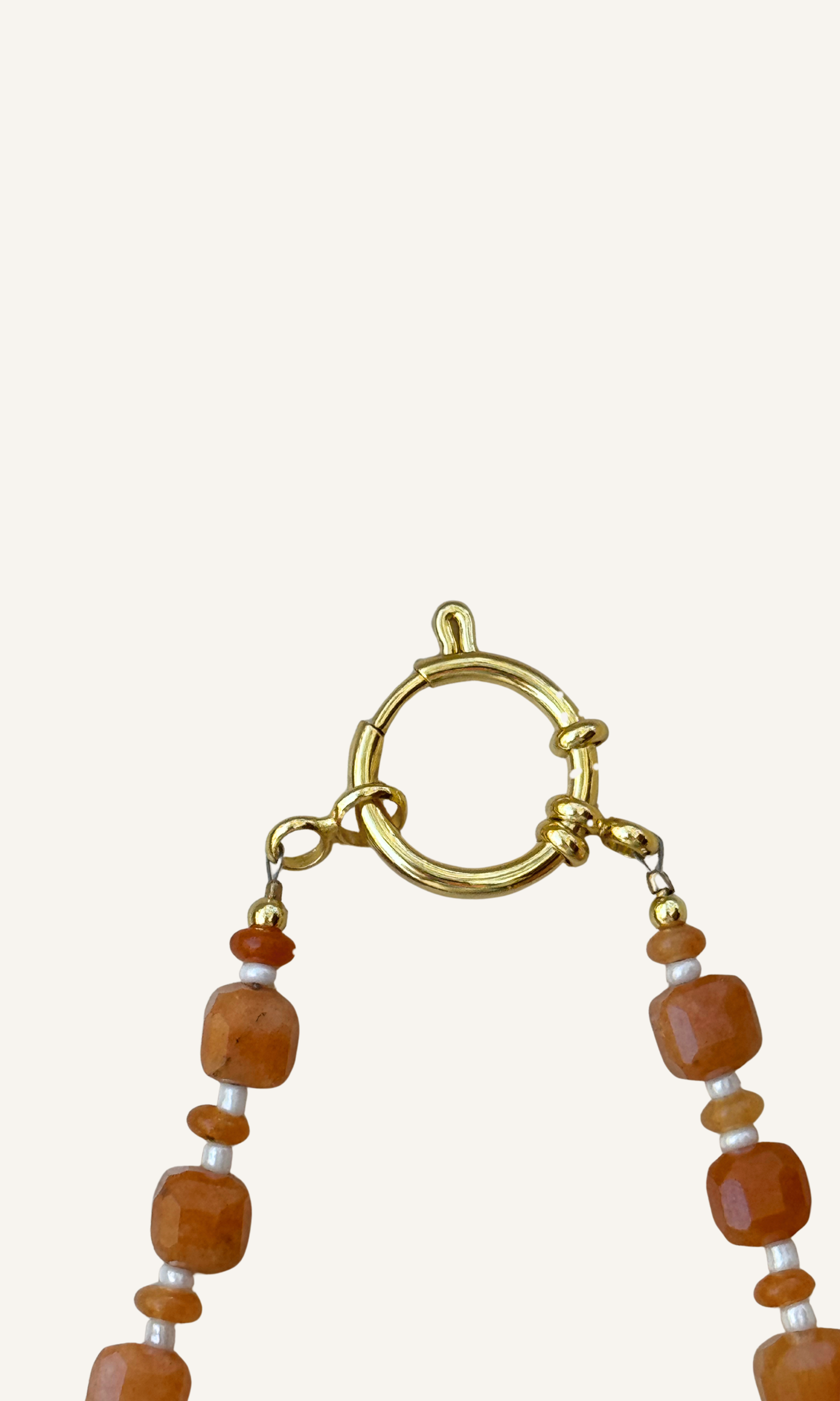 Orange Aventurine gemstones in various sizes with white spacer beads, gold filled findings, and a sailor clasp
