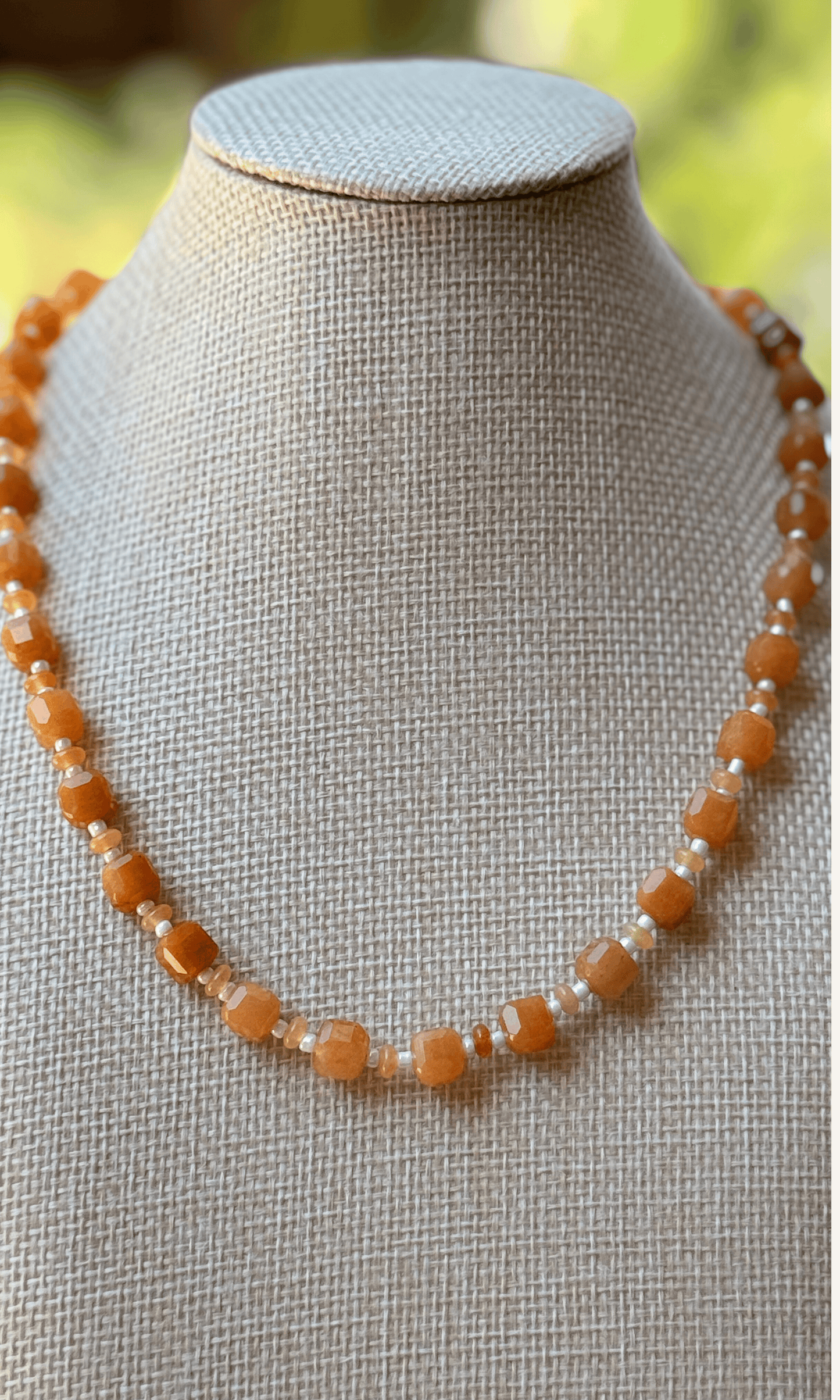 Orange Aventurine gemstones in various sizes with white spacer beads, gold filled findings, and a sailor clasp