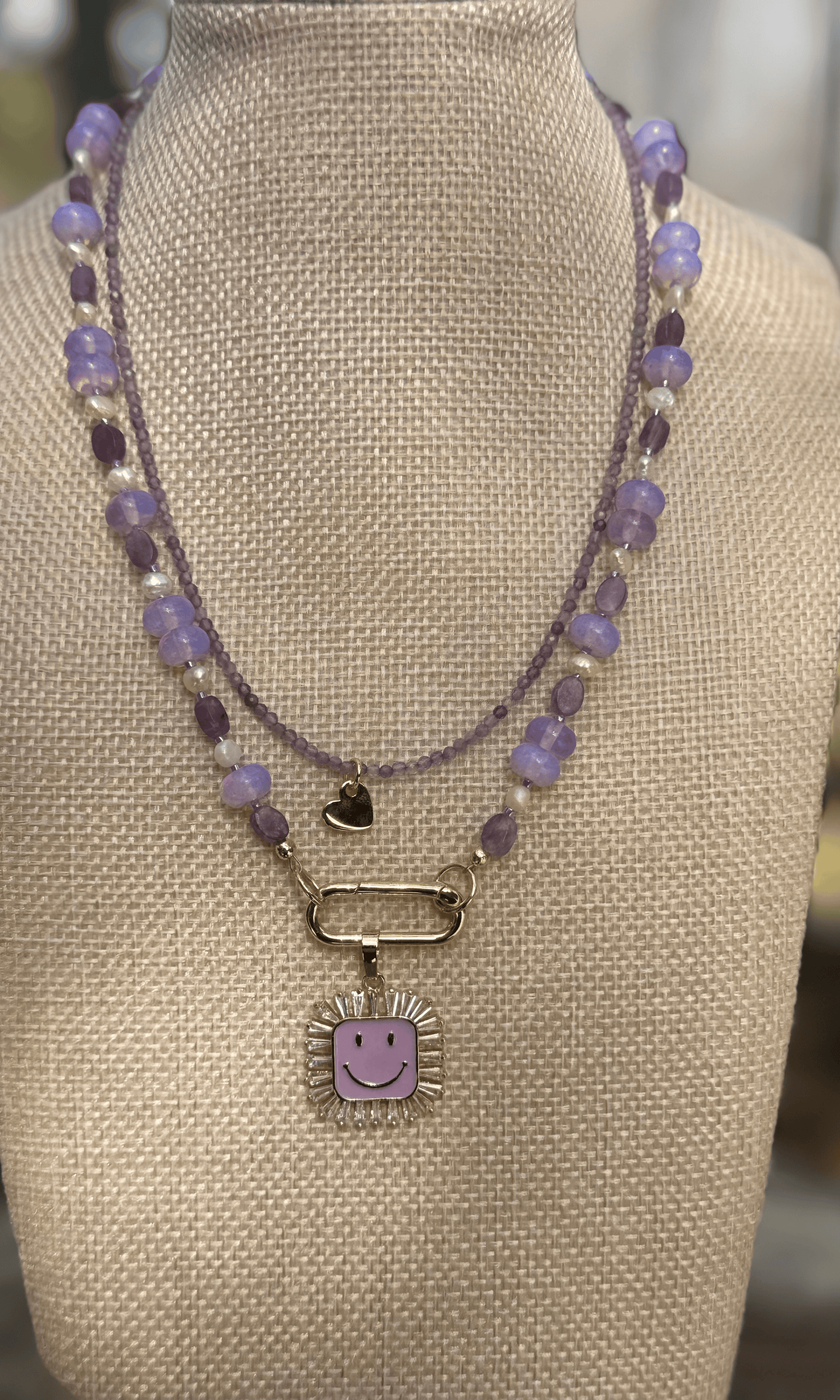 Dainty purple Amethyst necklace with gold filled heart charm and heart lobster clasp and Purple Multi-Gemstone Necklace with lepidolite, lavender quartz, freshwater pearls, and cz and enamel gold filled smiley face charm