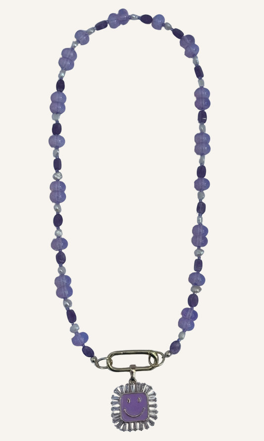 Purple multi-gemstone necklace with Lepidolite, Lavender Quartz, and Freshwater Pearls, a gold filled smiley face charm with enamel and cz, and gold filled push gate clasp