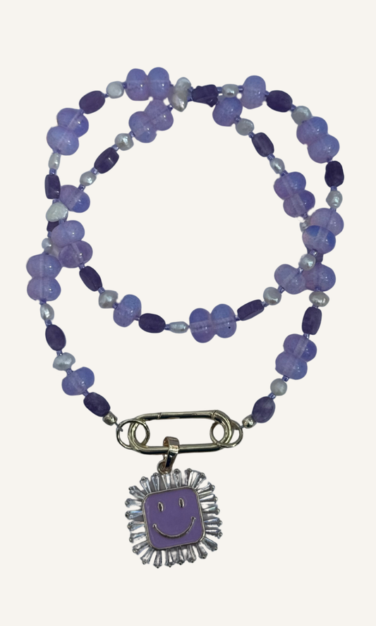 Purple multi-gemstone necklace with Lepidolite, Lavender Quartz, and Freshwater Pearls, a gold filled smiley face charm with enamel and cz, and gold filled push gate clasp