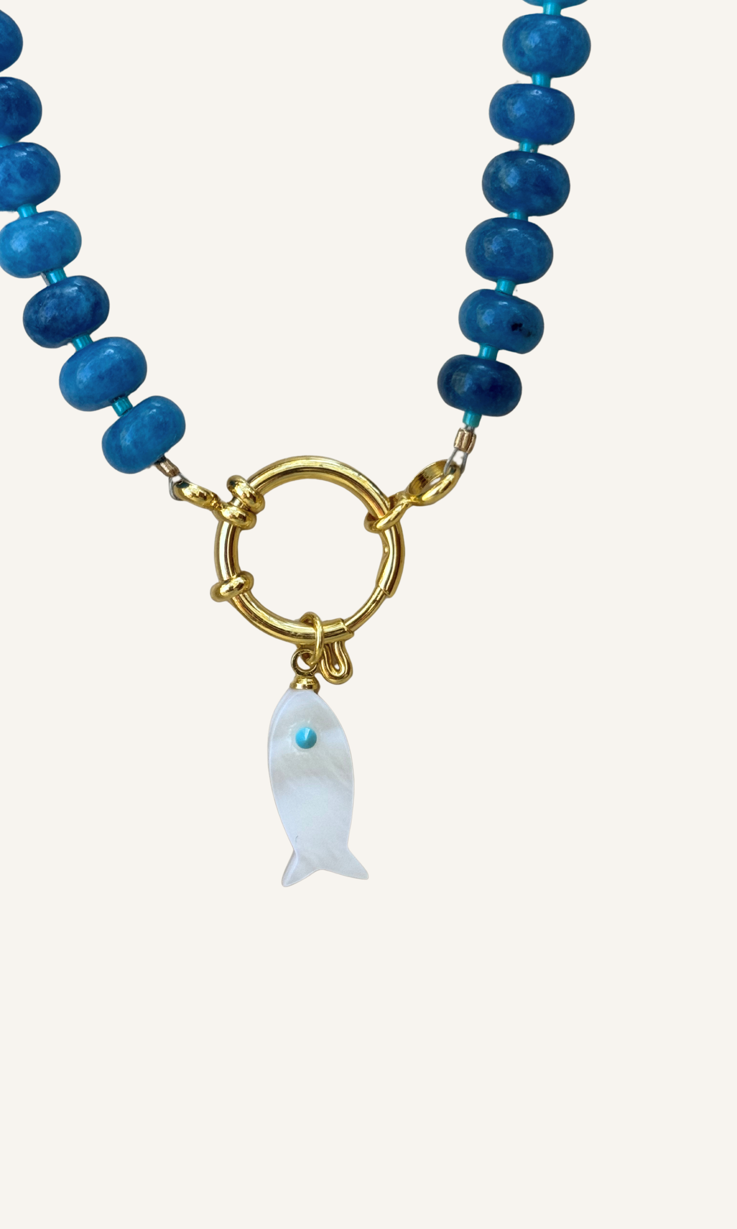 Sodalite candy necklace with a Mother of Pearl fish charm, gold filled findings, and a sailor clasp