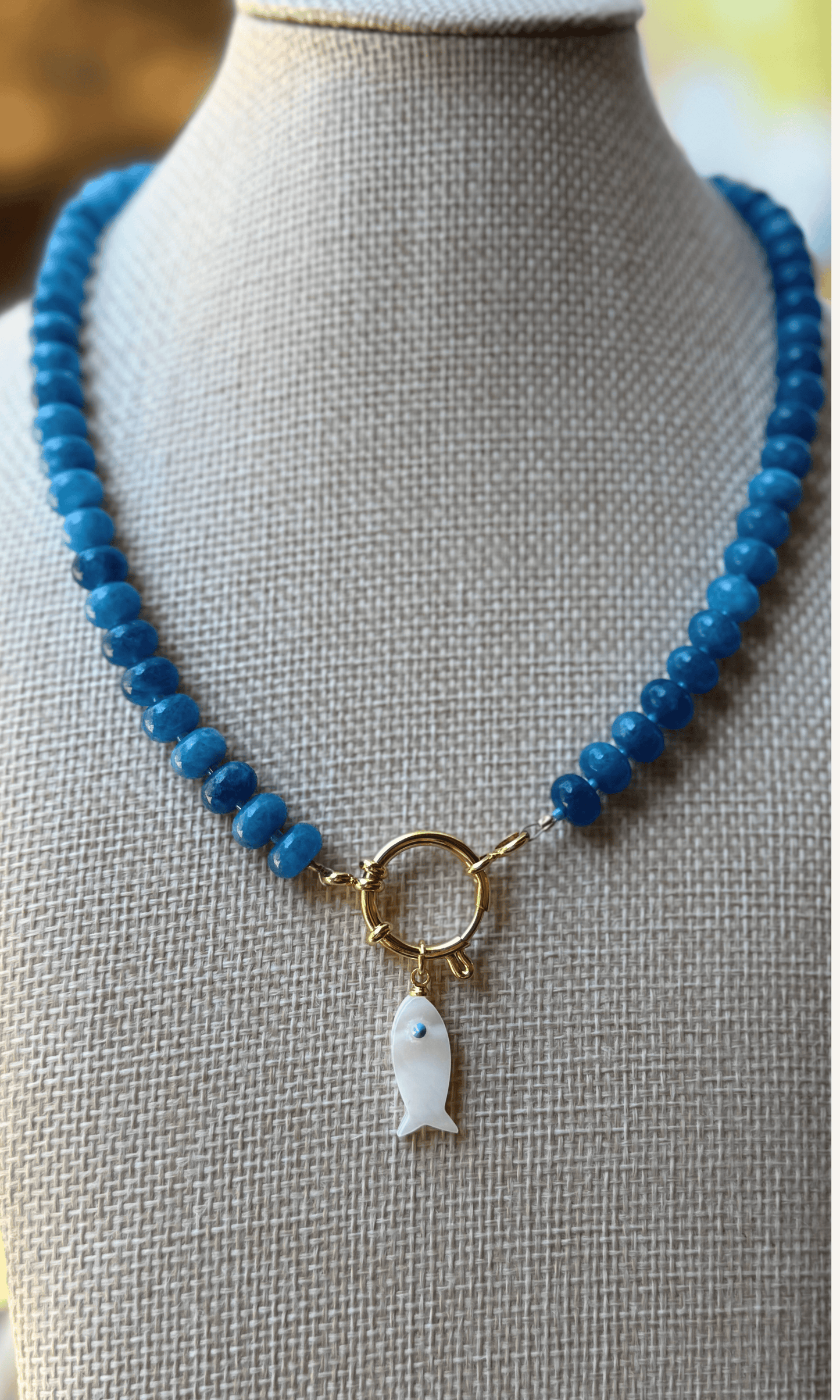Sodalite candy necklace with a Mother of Pearl fish charm, gold filled findings, and a sailor clasp