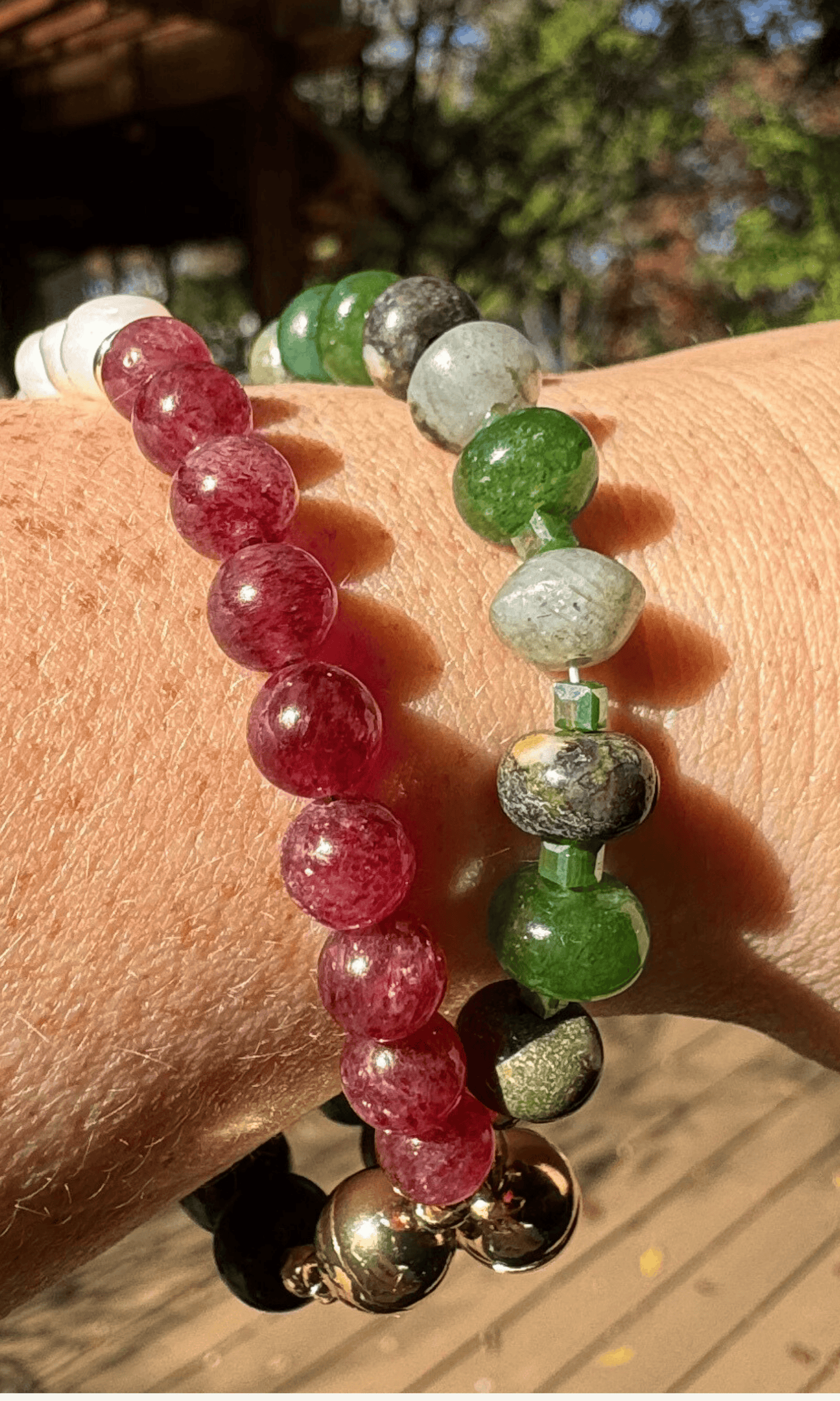 African Bloodstone, Strawberry Quartz, and Freshwater Pearl bracelet with a gold filled magnetic clasp paired with a green multi-gemstone bracelet with jade, jasper, labradorite, and aventurine
