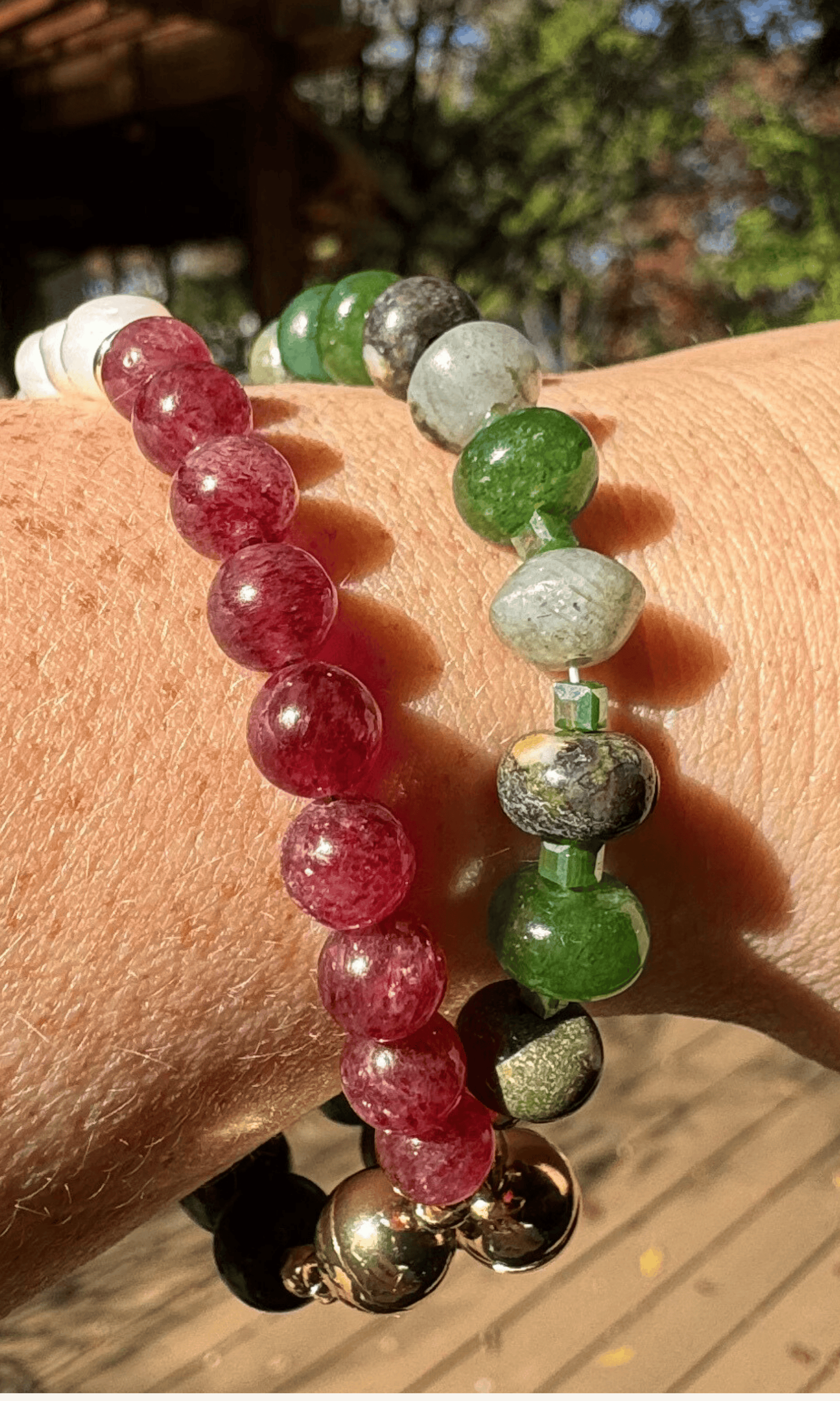African Bloodstone, Strawberry Quartz, and Freshwater Pearl bracelet with a gold filled magnetic clasp paired with a green multi-gemstone bracelet with jade, jasper, labradorite, and aventurine