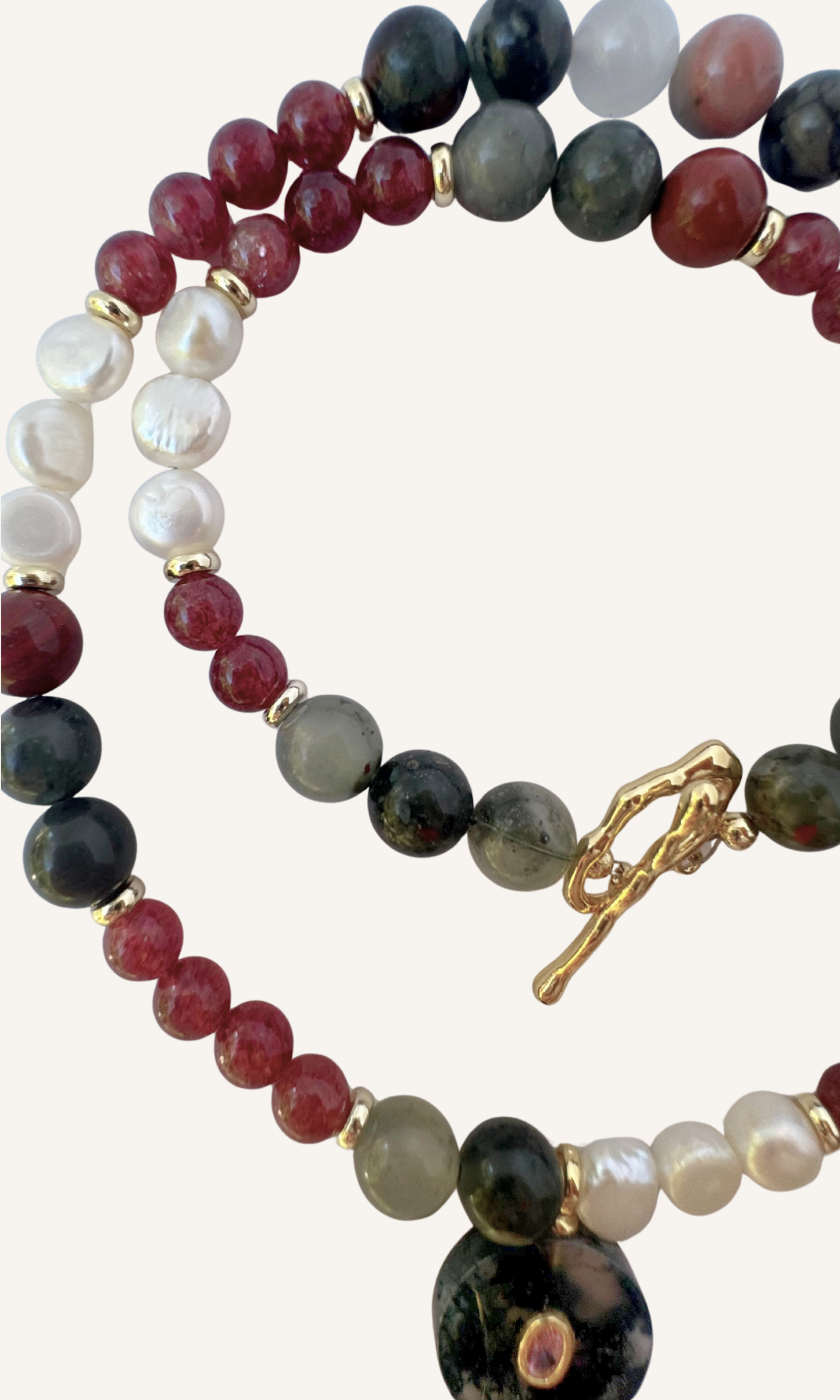 African Bloodstone, Strawberry Quartz, and Freshwater Pearl necklace with a Green Agate and Pink Cubic Zirconia charm, gold filled findings, and a toggle clasp